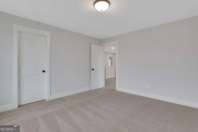carpeted spare room with baseboards