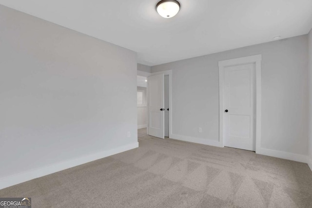 empty room with baseboards and carpet floors