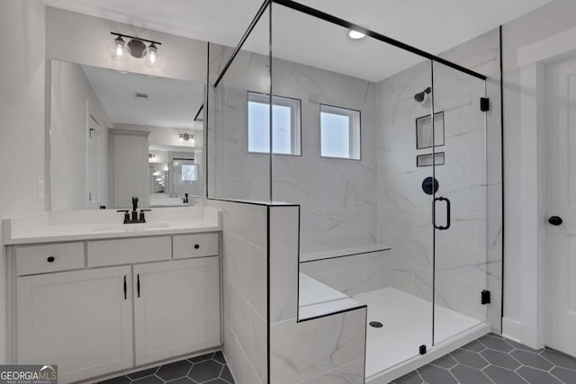 full bathroom featuring a shower stall, visible vents, and vanity