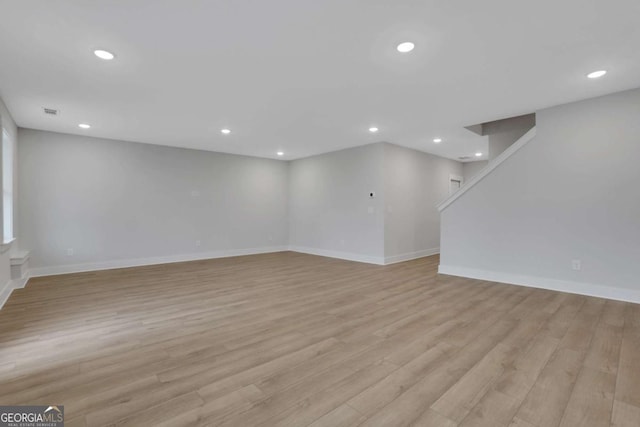 interior space with baseboards, recessed lighting, and light wood-type flooring
