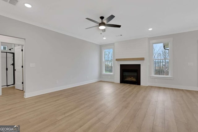 unfurnished living room featuring light wood finished floors, a wealth of natural light, baseboards, and a ceiling fan