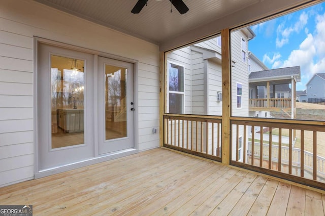unfurnished sunroom with a ceiling fan