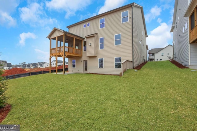 rear view of house featuring a yard