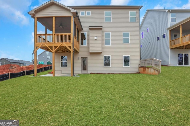 back of house with a ceiling fan, fence, a yard, and a patio