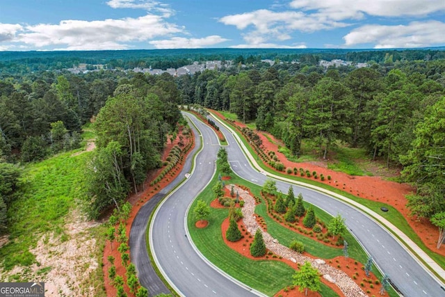 bird's eye view featuring a wooded view
