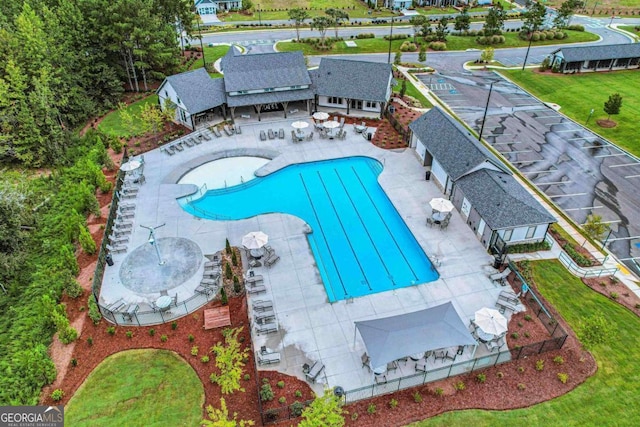 community pool featuring fence and a patio