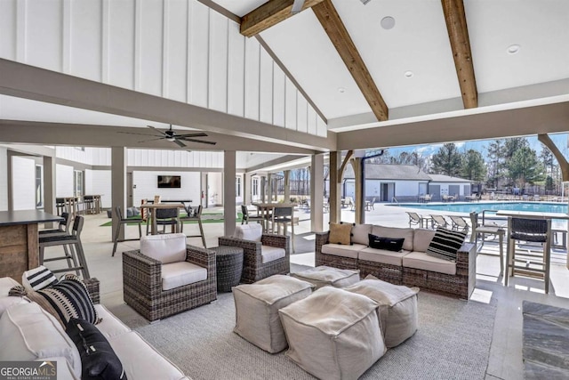 view of patio with an outdoor living space, outdoor dining space, a community pool, and a ceiling fan