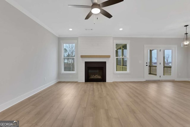 unfurnished living room featuring baseboards, a fireplace, ceiling fan, and light wood-type flooring