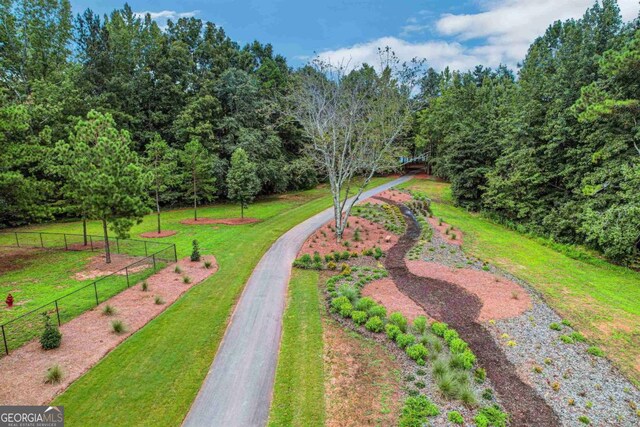 view of property's community with fence and a yard