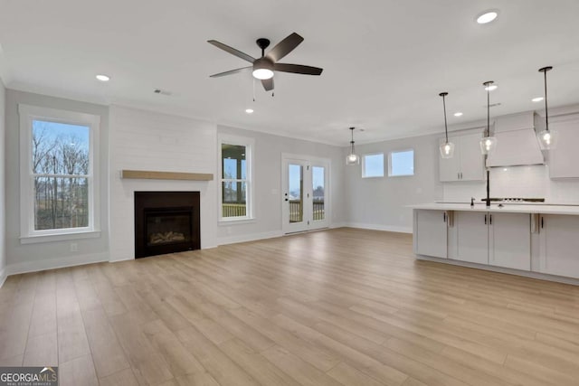 unfurnished living room with ceiling fan, recessed lighting, and light wood-type flooring