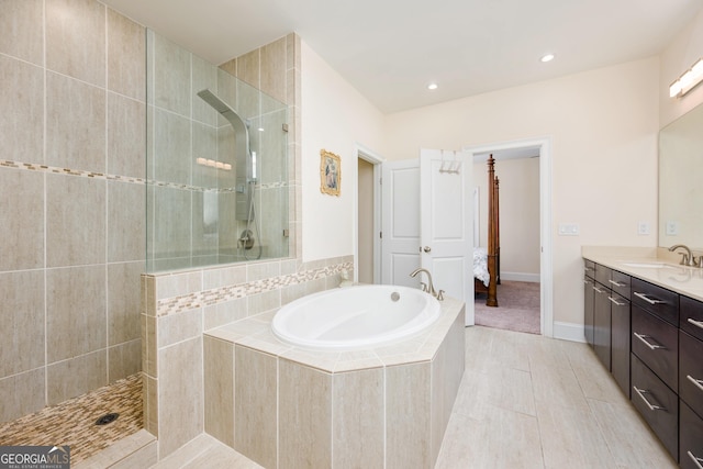 bathroom with a bath, walk in shower, tile patterned floors, recessed lighting, and vanity