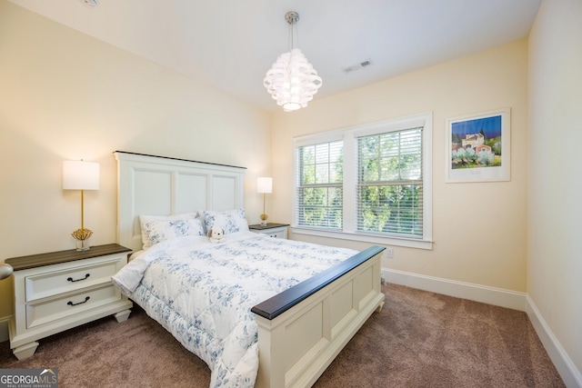 bedroom with a notable chandelier, carpet, baseboards, and visible vents