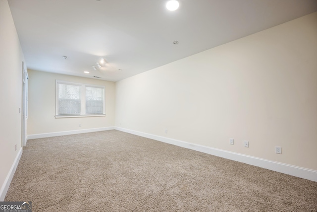 empty room with baseboards and carpet flooring