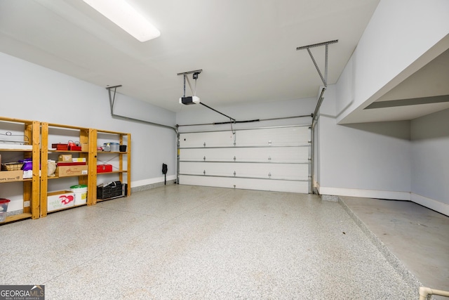 garage with baseboards and a garage door opener