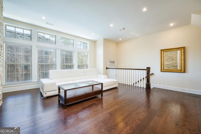 living area featuring an upstairs landing, recessed lighting, wood-type flooring, baseboards, and visible vents