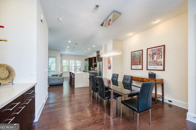 dining area with a notable chandelier, dark wood-type flooring, baseboards, visible vents, and recessed lighting