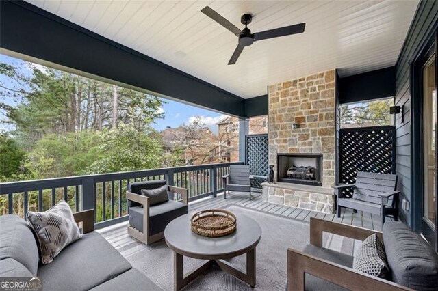 view of patio / terrace with an outdoor living space with a fireplace