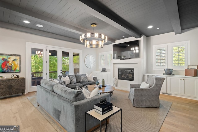 2587 Apple Valley Rd, Brookhaven, GA 30319 - living room featuring french doors, light wood finished floors, a chandelier, a wood ceiling with exposed beams, and a glass covered fireplace