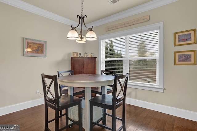 dining area featuring dark wood-type flooring, baseboards, and crown molding