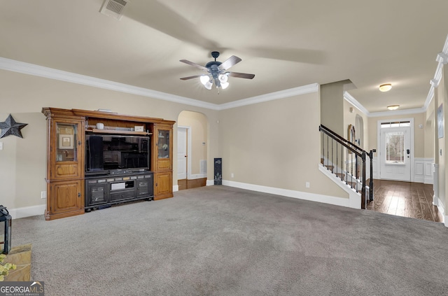 unfurnished living room featuring arched walkways, ceiling fan, visible vents, and carpet