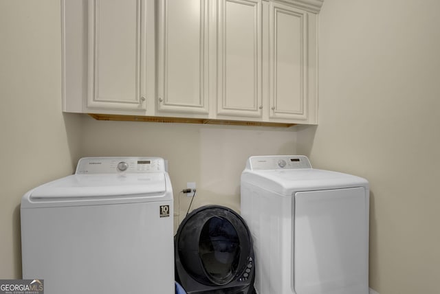 laundry area with cabinet space and separate washer and dryer
