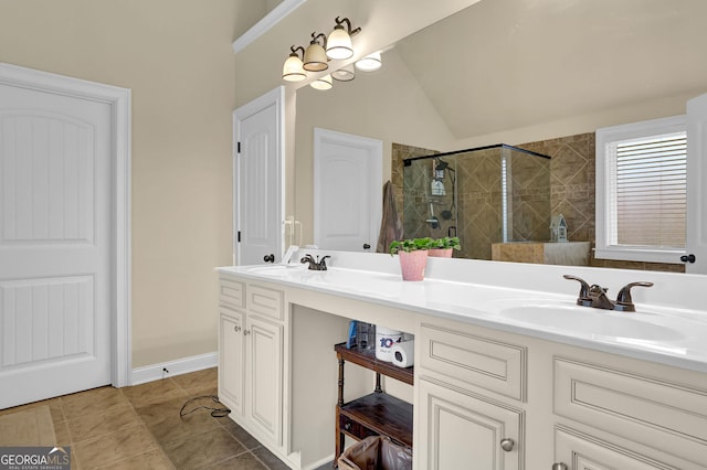 full bath with double vanity, lofted ceiling, a sink, and a shower stall