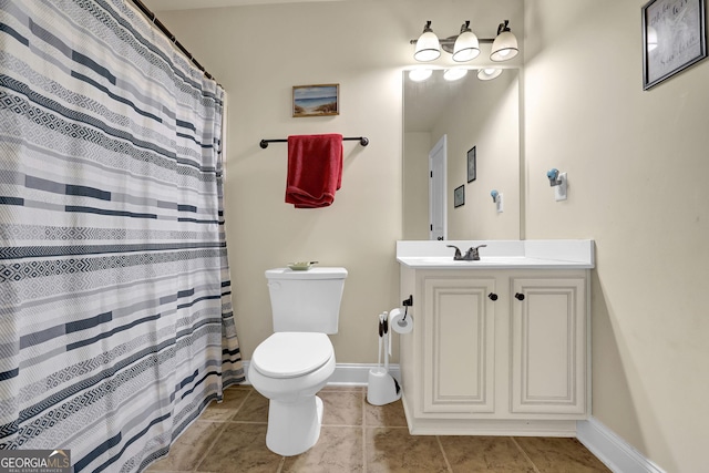 full bath with toilet, vanity, tile patterned floors, and baseboards