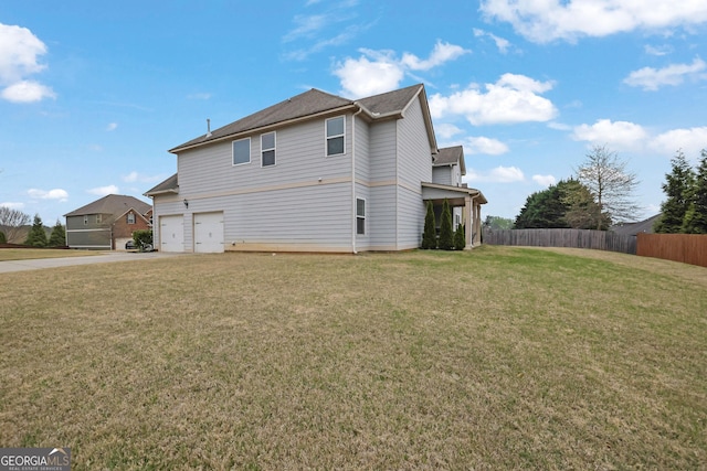 view of property exterior with concrete driveway, fence, a garage, and a yard
