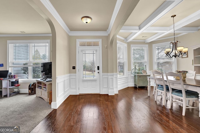 entrance foyer featuring a notable chandelier, wood finished floors, beamed ceiling, and plenty of natural light
