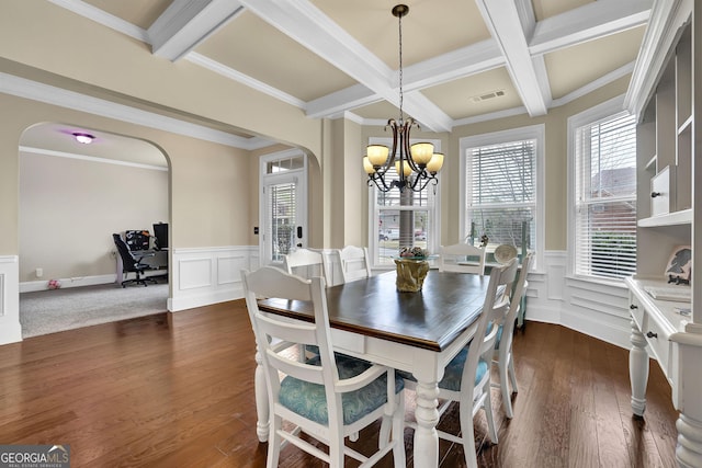 dining area with visible vents, a notable chandelier, arched walkways, and beam ceiling