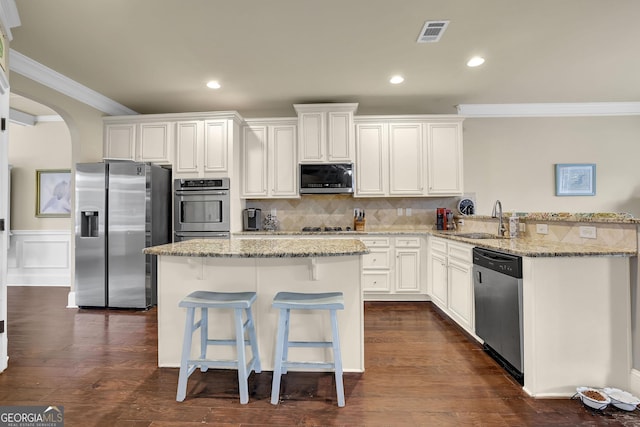 kitchen with a sink, appliances with stainless steel finishes, visible vents, arched walkways, and ornamental molding