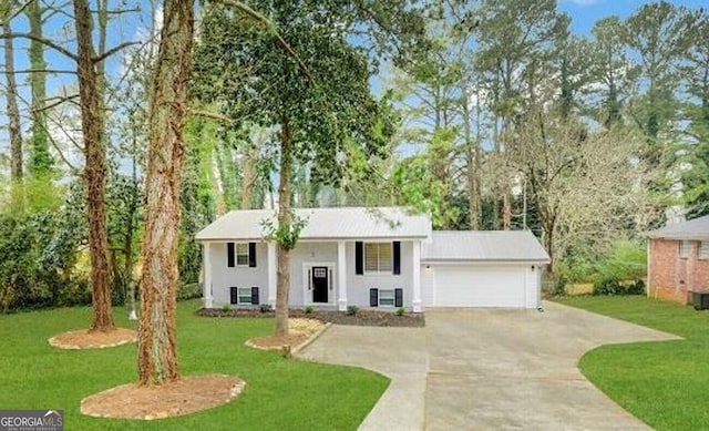 3363 Wesley Chapel Rd, Decatur, GA 30034 - bi-level home with a front yard, an attached garage, stucco siding, and concrete driveway