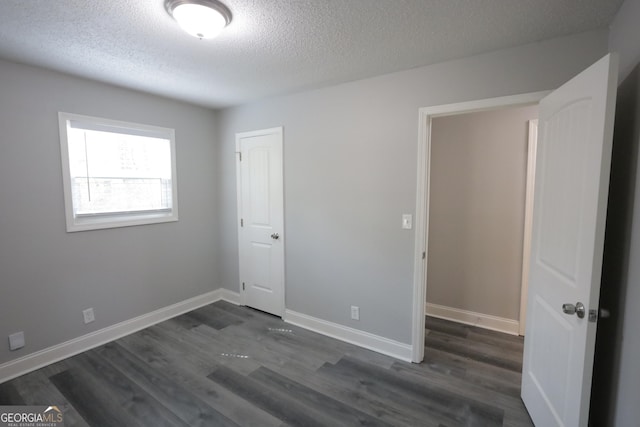 3363 Wesley Chapel Rd, Decatur, GA 30034 - unfurnished bedroom featuring dark wood-type flooring, baseboards, and a textured ceiling
