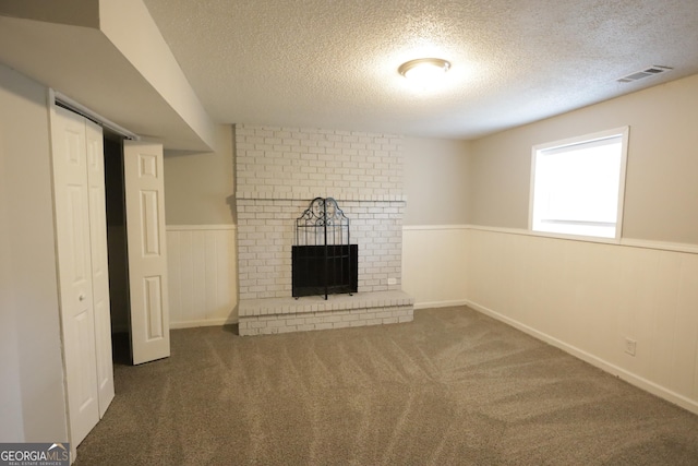 3363 Wesley Chapel Rd, Decatur, GA 30034 - unfurnished living room with a wainscoted wall, a textured ceiling, visible vents, carpet, and a fireplace