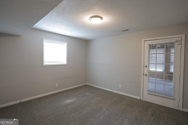 3363 Wesley Chapel Rd, Decatur, GA 30034 - spare room featuring dark carpet, baseboards, a textured ceiling, and visible vents