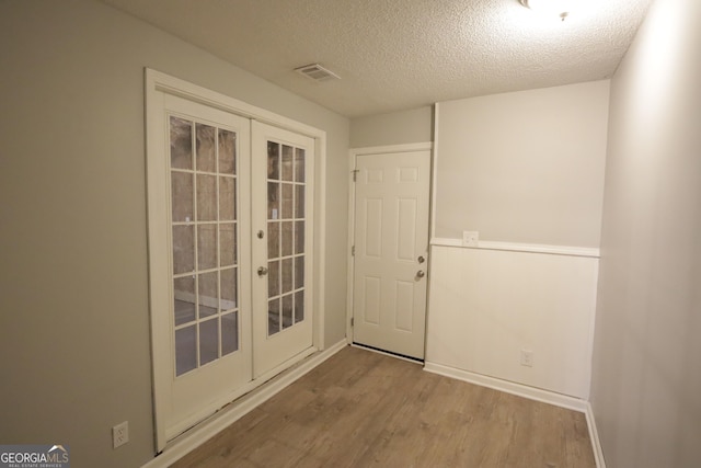 3363 Wesley Chapel Rd, Decatur, GA 30034 - doorway with french doors, visible vents, a textured ceiling, and wood finished floors