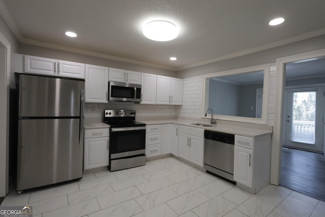 3363 Wesley Chapel Rd, Decatur, GA 30034 - kitchen featuring ornamental molding, light countertops, a sink, and stainless steel appliances