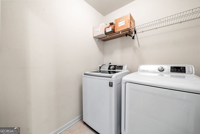 57 Sorghum Ct, Dallas, GA 30157 - laundry room with washing machine and clothes dryer, light tile patterned floors, and baseboards