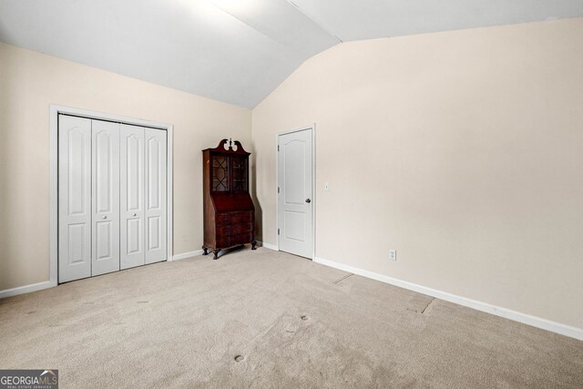 57 Sorghum Ct, Dallas, GA 30157 - unfurnished bedroom with lofted ceiling, carpet, baseboards, and a closet