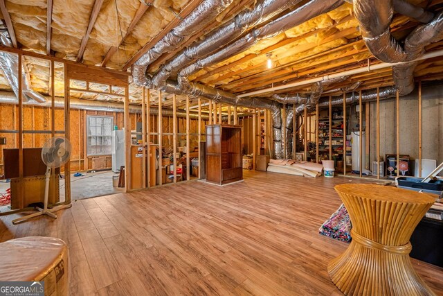 57 Sorghum Ct, Dallas, GA 30157 - unfinished below grade area with gas water heater, freestanding refrigerator, and wood finished floors