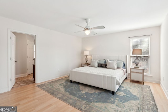 bedroom with baseboards, ceiling fan, and light wood finished floors