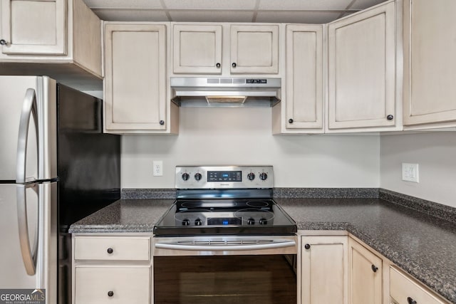 kitchen with a drop ceiling, stainless steel appliances, and under cabinet range hood
