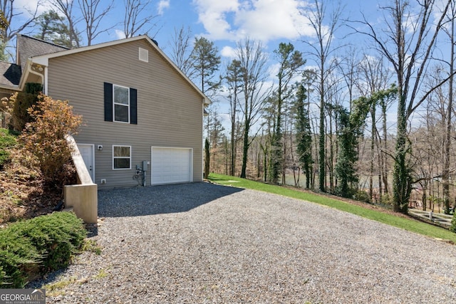 view of property exterior featuring driveway and a garage