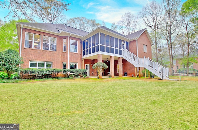 exterior space featuring brick siding, a yard, stairway, and a sunroom