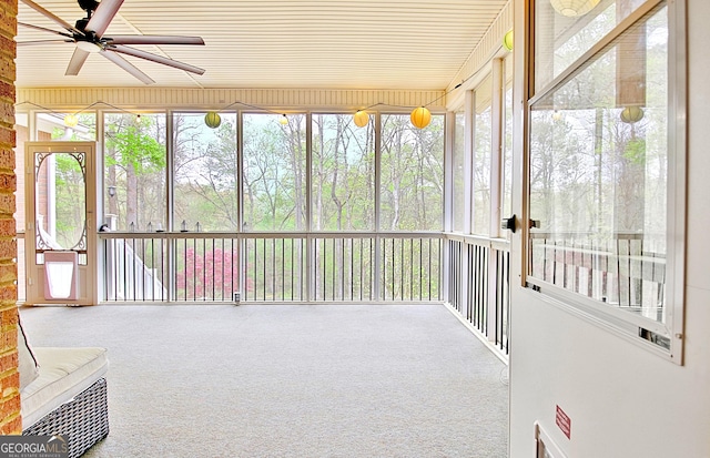 unfurnished sunroom with a ceiling fan