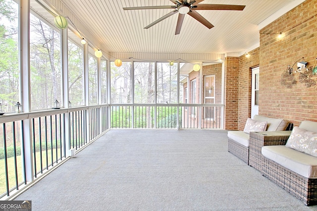 sunroom with ceiling fan and plenty of natural light