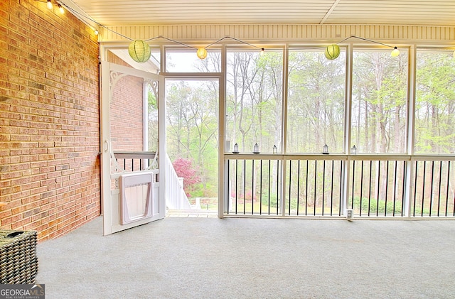 unfurnished sunroom featuring a wealth of natural light