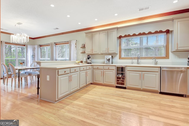 kitchen with beverage cooler, stainless steel dishwasher, ornamental molding, light wood-type flooring, and a notable chandelier