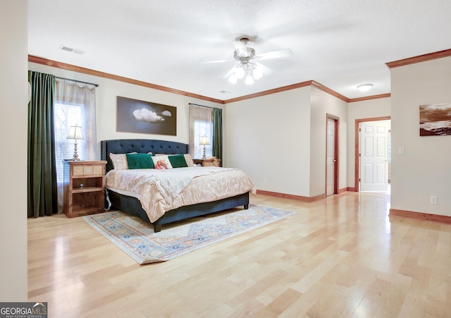 bedroom with ornamental molding, multiple windows, baseboards, and light wood-type flooring