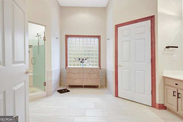 165 Hideaway Dr, Fayetteville, GA 30215 - bathroom featuring vanity, a shower stall, a wainscoted wall, and tile walls